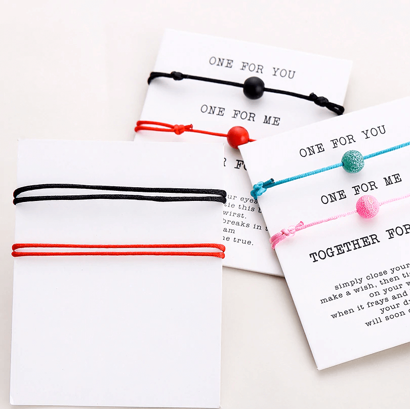 Back of Red string and black string natural stone pair of bracelets