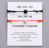 Red string and black string natural stone pair of bracelets on gift card