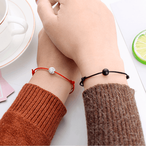 Holding hands with string bracelets with natural stone charms