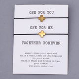 pair of 2 black string bracelets with golden cross charm