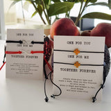pair of 2 black string bracelets with golden cross charm