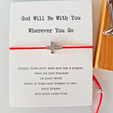 silver cross and red string bracelet
