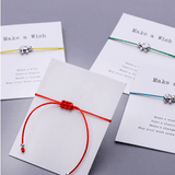 back of a gift card red string bracelet