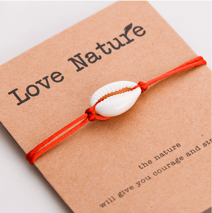 Natural shell red string bracelet on a gift card