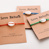 3 Natural shell red string bracelets on their gift cards