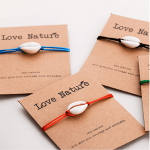 three bracelet cards with white natural shells