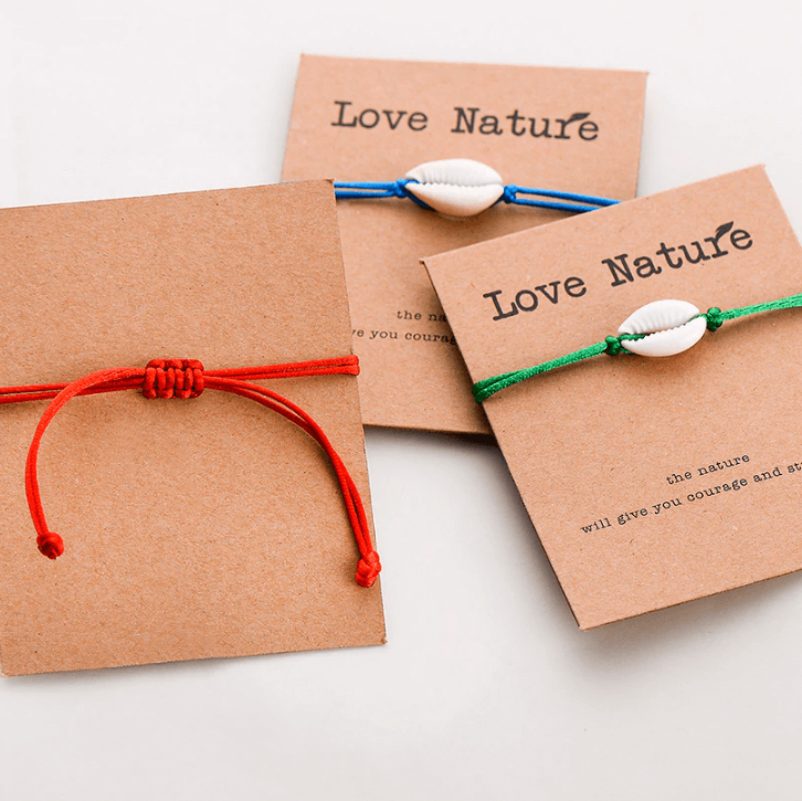 back of the gift card with a red string bracelet